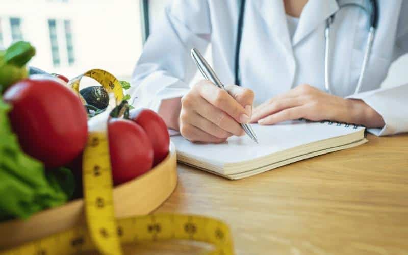 naturopathic doctor writing in notepad
